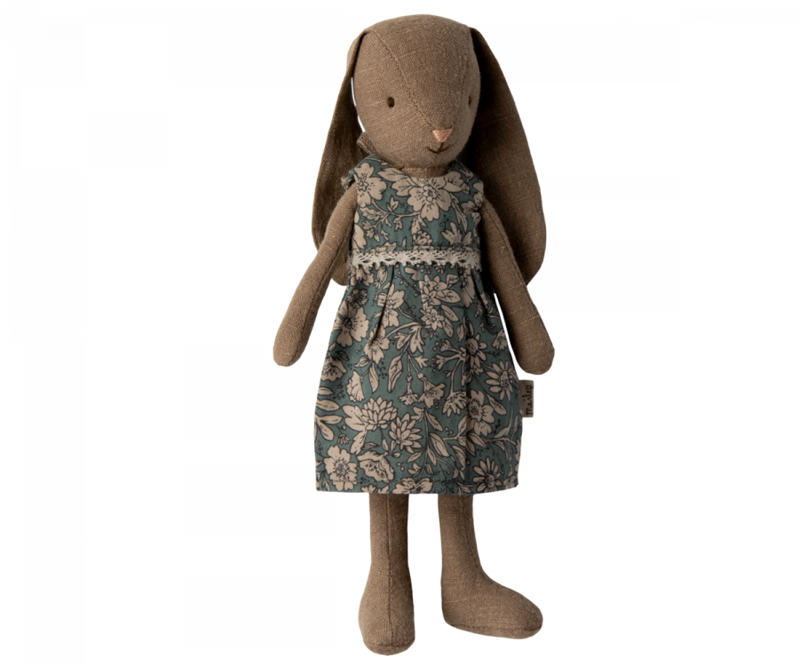 Stuffed animals positioned in a child's Maileg Bunny with Dress, Size 1 Dollhouse Toy setting with a miniature lamp and crib.